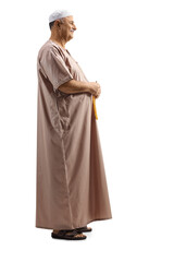 Full length profile shot of a muslim man in traditional clothes
