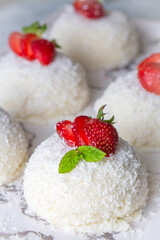 Delicious milk dessert; cup dessert with coconut and strawberry (Turkish name; fincan tatlisi