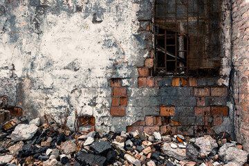 Fototapeta na wymiar Old broken brick wall with a lattice window