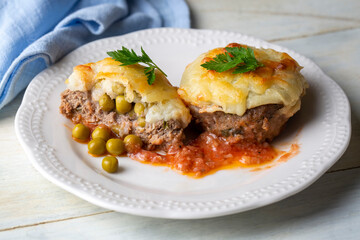 Turkish Food Hasanpasa Kofte - Kofta with Puree - Meatball with Bechamel Sauce and Green Peas. Traditional Food.