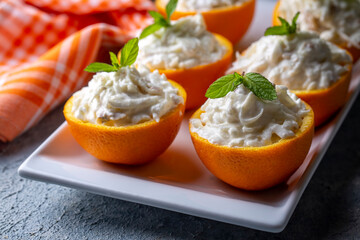 Celery salad with apple and walnuts served in orange cups.