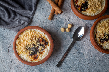Baked rice pudding turkish milky dessert sutlac in earthenware casserole with hazelnuts