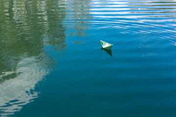 White paper skiffs float on water