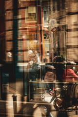 People walking through a restaurant window