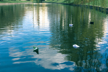 Many paper skiffs float on the water