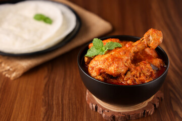 Spicy chicken leg curry , Rice pathiri , Pathir flat bread Kerala Tamil Nadu India SriLanka. Popular traditional South Indian breakfast dish of Malabar Muslims Ramadan Ramzan, Eid festival Rice roti