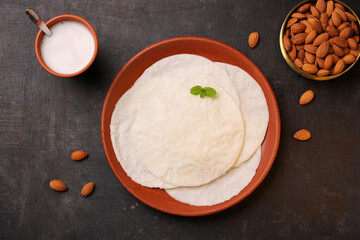 Rice Pathiri pathir flat bread with spicy chicken curry, coconut milk Kerala India SriLanka. Popular traditional South Indian breakfast dish Malabar Muslims on Ramadan Ramzan, Eid festival Rice roti