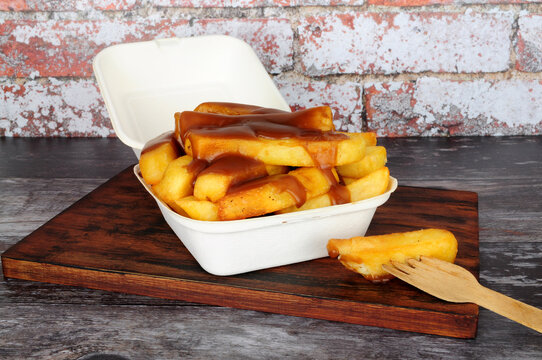Chips and gravy meal in a take away box with lid