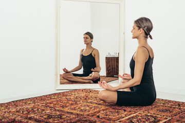 Woman doing yoga while sitting and meditating