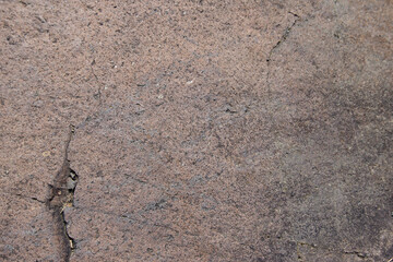 Brown andesite stone surface texture. Brown-grey rock with  cracks and cavities. Template for background