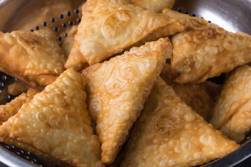 samosa or samusa, deep fried, triangular shaped pastry filled with spicy potato, popular snack in south asia
