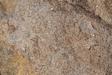 Brown andesite stone surface texture. Brown-grey rock with  cracks and cavities. Template for background