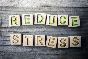 Reduce Stress Written On Wooden Blocks On A Board