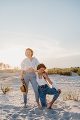 two young women having fun on the sunset beach