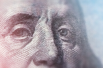 Fototapeta premium macro texture of the face of American President Franklin on paper bill, close-up, toned image, soft focus
