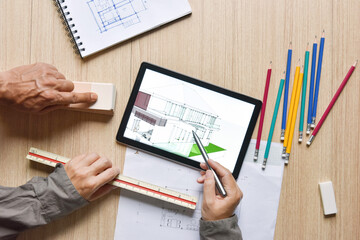 a tablet showing architectural drawing design detail selection of building color with digital pens...