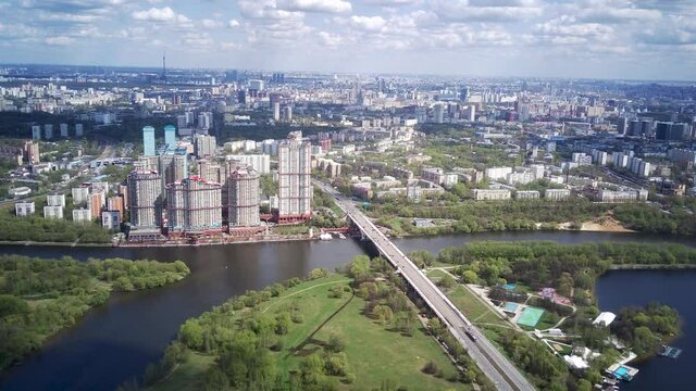 Amazing high angle top drone view on Strogino and Shchukino	district which are situated in beautiful green river park.

