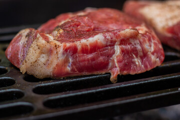 Beautiful pork steak fried on a cast iron grill close-up