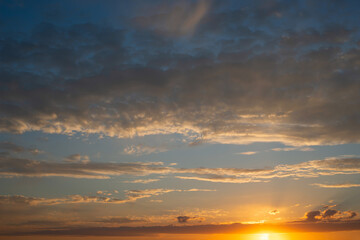 Fototapeta na wymiar Warm colorful sunrise with sparse clouds