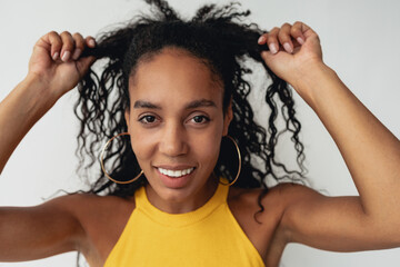 attractive black african american woman posing in stylish hipster outfit on white background