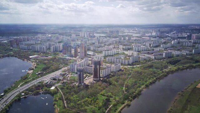 Amazing high angle top drone view on Strogino and Shchukino	district which are situated in beautiful green river park.
