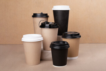 Lot of drinking paper coffee cups on cardboard background