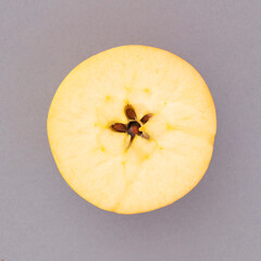 Half apple  on a gray background