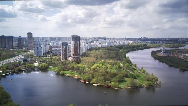 Amazing high angle top drone view on Strogino and Shchukino	district which are situated in beautiful green river park.
