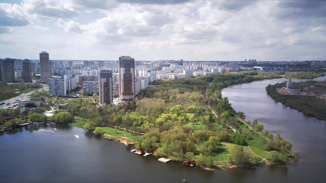 Amazing high angle top drone view on Strogino and Shchukino	district which are situated in beautiful green river park.
