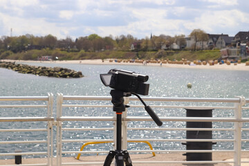 Selective focus view at a camera filming at a yacht port in Kiel in Germany