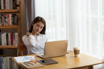 Businesswoman feeling pain back after sedentary computer work sitting in bad posture in office