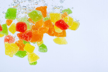 Multicolored little candies in water