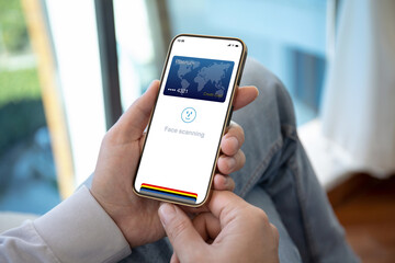 male hands holding phone with face scanning id on screen