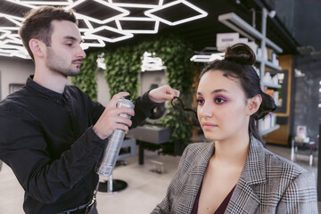 The master makes a hairstyle for the client. Retro haircut of the 1980s.
