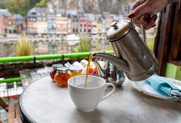 Breakfast served in hotel room with view on Maas river in Dinant, Belgium during Covid-19 restrictions