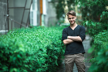 Waist portrait of a nice young man outdoors.