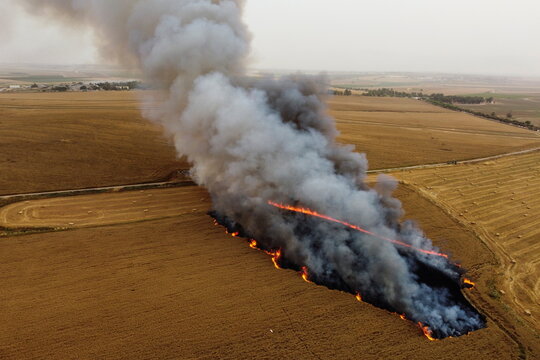 A part of a wheat field goes in flames after Palestinians in Gaza sent incendiary balloons over the border near Nir Am
