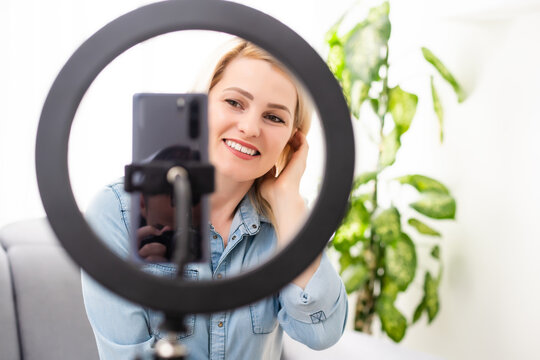 blogger woman records video with round lamp