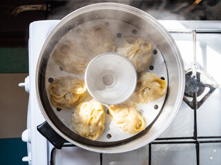 top view of homemade manti are cooking in steamer - obrazy, fototapety, plakaty
