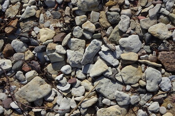 Background of gray and brown multicolor stones on the beach during the daytime