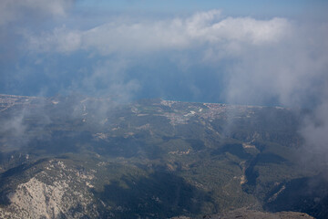 Mediterranean sea and cost view from the mountain summit through clouds