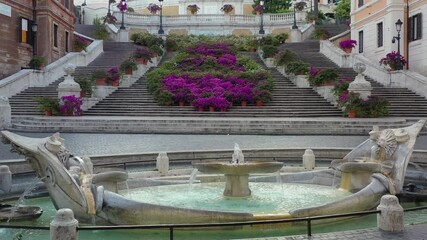 Piazza di Spagna in Rome, The Spanish Steps with flowers. Trinità dei Monti. Spectacular aerial drone shot of flower covered stairway on a spring day.