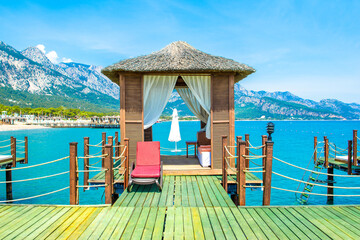 Wooden beach pavilions on the shore of a sandy beach