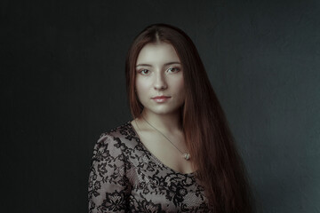 girl with long flowing hair with a pendant on her neck