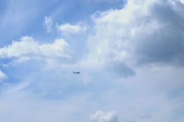 Against the background of the sky covered with clouds, the plane flies
