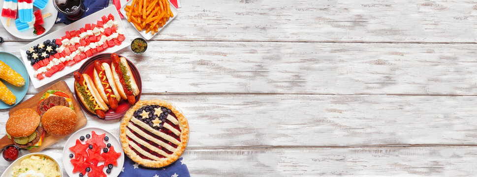 Fourth of July, patriotic, American themed food. Top view side border on a white wood banner background. Copy space.