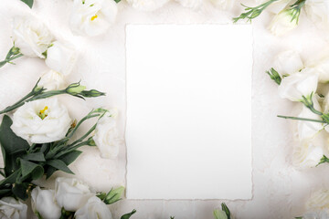 Fototapeta na wymiar Vertical 5x7 empty card mockup with blooming white eustoma lisianthus flowers, design element for wedding invitation, thank you or greeting card. Spring background
