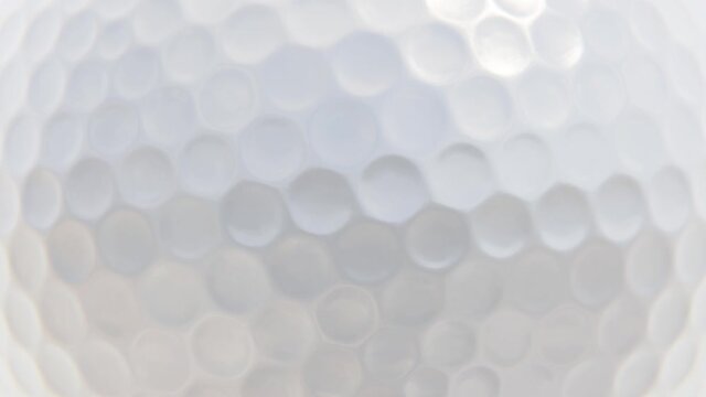 360-degree seamless looping spin of the white golf ball surface as background realistic 3D animation rendered in UHD