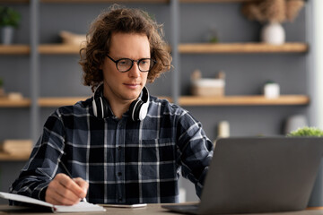 Serious Businessman Taking Notes Writing Business Report In Modern Office