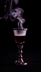 Royal glass with precious stones, red dry wine and magical smoke.